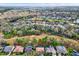 Expansive aerial view of a residential neighborhood with mature trees and a home featuring a screened-in pool at 9617 Norchester Cir, Tampa, FL 33647