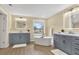 Bright bathroom with dual vanities, a freestanding tub, and modern finishes throughout the space at 9617 Norchester Cir, Tampa, FL 33647