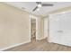 Neutral bedroom with a ceiling fan, stairs, and closet at 9617 Norchester Cir, Tampa, FL 33647