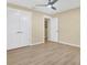 Neutral bedroom with a ceiling fan, light hardwood floors and closet at 9617 Norchester Cir, Tampa, FL 33647