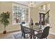 Dining room featuring a modern glass table and views of the front yard at 9617 Norchester Cir, Tampa, FL 33647