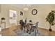 Dining area features modern chandelier and view into kitchen at 9617 Norchester Cir, Tampa, FL 33647