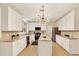 Well-lit kitchen showcasing white cabinets, granite countertops, center island, and stainless steel appliances at 9617 Norchester Cir, Tampa, FL 33647