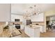 Contemporary kitchen with white cabinetry, granite countertops, stainless steel appliances and center island at 9617 Norchester Cir, Tampa, FL 33647
