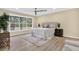 Inviting main bedroom showcasing a serene atmosphere and backyard views from the large window at 9617 Norchester Cir, Tampa, FL 33647