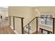 Modern staircase with metal railings and wood steps leading to upper level at 9617 Norchester Cir, Tampa, FL 33647