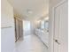 Bright bathroom featuring double vanity with modern fixtures and marble floors, plus glass enclosed shower at 10126 Zennia Ln, Parrish, FL 34219