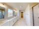 Bright bathroom with double vanities, modern fixtures, and a walk-in shower with glass door at 10126 Zennia Ln, Parrish, FL 34219