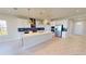 Well-lit kitchen with a large island, stainless steel appliances, and a contemporary backsplash at 10126 Zennia Ln, Parrish, FL 34219