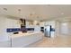 Modern kitchen with a spacious island, stainless steel appliances, and stylish blue backsplash at 10126 Zennia Ln, Parrish, FL 34219