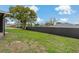 Large backyard with a privacy fence and a mature tree at 10200 Sunburst Ct, Spring Hill, FL 34608