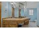 Bathroom features a long countertop with double sinks, pendant lights, and a large mirror at 10200 Sunburst Ct, Spring Hill, FL 34608