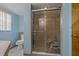 Bathroom features a toilet and glass shower with a bench inside at 10200 Sunburst Ct, Spring Hill, FL 34608
