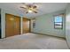 A light filled bedroom features two closets, a ceiling fan and two windows for natural light at 10200 Sunburst Ct, Spring Hill, FL 34608