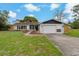 Charming single-story home with a well-manicured lawn, stone accents and attached two car garage at 10200 Sunburst Ct, Spring Hill, FL 34608