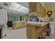 Bright kitchen with a skylight, tile flooring, and light wood cabinets and counters at 10200 Sunburst Ct, Spring Hill, FL 34608
