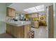 A kitchen with a dining area, wooden cabinetry, tile flooring and updated appliances at 10200 Sunburst Ct, Spring Hill, FL 34608