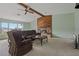 Bright living room showcases a stone fireplace, beamed ceiling, and comfortable seating arrangement at 10200 Sunburst Ct, Spring Hill, FL 34608