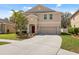 A home with a two-car garage, red front door, and landscaping at 12307 Duckett Ct, Spring Hill, FL 34610
