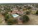 Aerial view of community clubhouse, showcasing a sparkling pool and playground at 14215 Presteign Ln, Spring Hill, FL 34609