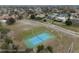 Aerial shot features a community tennis court surrounded by lush greenery at 14215 Presteign Ln, Spring Hill, FL 34609