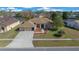 Attractive one-story home with a manicured lawn, landscaping, and a long driveway at 14215 Presteign Ln, Spring Hill, FL 34609