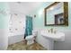 Bright bathroom featuring a pedestal sink, decorative tiled tub, and stylish fixtures at 14215 Presteign Ln, Spring Hill, FL 34609