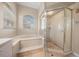 Bathroom featuring a tub and shower with tiled floors and natural light at 14215 Presteign Ln, Spring Hill, FL 34609