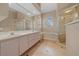 Bathroom with a double sink vanity, bathtub, shower, and tile floors at 14215 Presteign Ln, Spring Hill, FL 34609