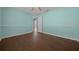 Bright bedroom with wood-look flooring and view to the pool area, offering a serene and relaxing atmosphere at 14215 Presteign Ln, Spring Hill, FL 34609