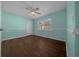 Bedroom features wood-look flooring, ample natural light, and a comfortable atmosphere for relaxation at 14215 Presteign Ln, Spring Hill, FL 34609