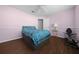 Cozy bedroom with light pink walls, wood-look flooring, ceiling fan, and a comfortable ambiance at 14215 Presteign Ln, Spring Hill, FL 34609