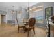 Bright dining area featuring tile floors, large arched window, and ornate dining table with upholstered chairs at 14215 Presteign Ln, Spring Hill, FL 34609