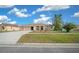 Charming single-story home with a well-manicured lawn and a welcoming front entrance at 14215 Presteign Ln, Spring Hill, FL 34609