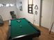 Game room with pool table featuring wooden floor, chair, and overhead lighting at 14215 Presteign Ln, Spring Hill, FL 34609