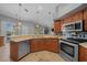 Bright kitchen with stainless steel appliances, ample counter space, tile floors, and view of the living area at 14215 Presteign Ln, Spring Hill, FL 34609