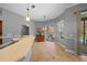 Bright kitchen with dining nook, sliding glass doors to the pool area, and stylish pendant lighting at 14215 Presteign Ln, Spring Hill, FL 34609