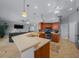 Open-concept kitchen featuring a breakfast bar, stainless steel appliances, and seamless flow into the living area at 14215 Presteign Ln, Spring Hill, FL 34609