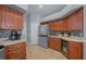 Well-equipped kitchen with wood cabinets, stainless steel appliances, wine cooler, and tiled backsplash at 14215 Presteign Ln, Spring Hill, FL 34609