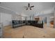 Large living area featuring tile floors, sectional sofa, and views of the front entrance and dining area at 14215 Presteign Ln, Spring Hill, FL 34609