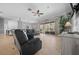 Open living area with tile floors, large sliding doors to lanai, and comfortable seating at 14215 Presteign Ln, Spring Hill, FL 34609