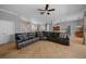 Spacious living room featuring tile floors, large sectional sofa, and neutral color palette at 14215 Presteign Ln, Spring Hill, FL 34609