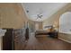 Spacious main bedroom with wooden floor, ceiling fan, dresser, and access to outside at 14215 Presteign Ln, Spring Hill, FL 34609