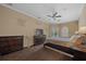 Cozy bedroom with wooden floor, dresser, ceiling fan, and large window at 14215 Presteign Ln, Spring Hill, FL 34609