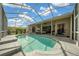 Inviting screened-in pool boasts crystal-clear water, a spacious deck, and seamless access to the home's living space at 14215 Presteign Ln, Spring Hill, FL 34609