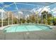 Enjoy the inviting screened-in pool with beautiful tile accents, perfect for relaxation and outdoor fun at 14215 Presteign Ln, Spring Hill, FL 34609
