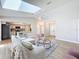 Cozy living space showcasing an open floor plan with a view of the kitchen, dining area, and stylish furnishings at 4351 Castle Ave, Spring Hill, FL 34609