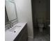 Bathroom featuring a light-up mirror, gray vanity with white countertop at 5641 Quist Dr, Port Richey, FL 34668
