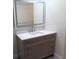 Bathroom featuring white walls, white countertop and modern light-up mirror at 5641 Quist Dr, Port Richey, FL 34668