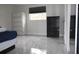 Bedroom featuring tile floors, black dresser, white cabinet and a window at 5641 Quist Dr, Port Richey, FL 34668